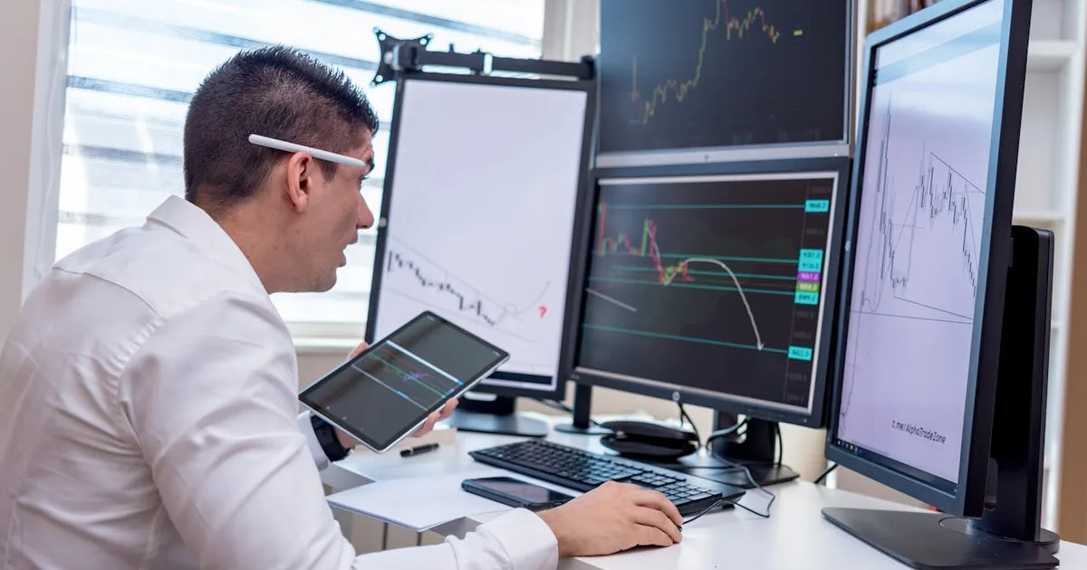 Trader analyzing multiple screens — but which account is the real one?