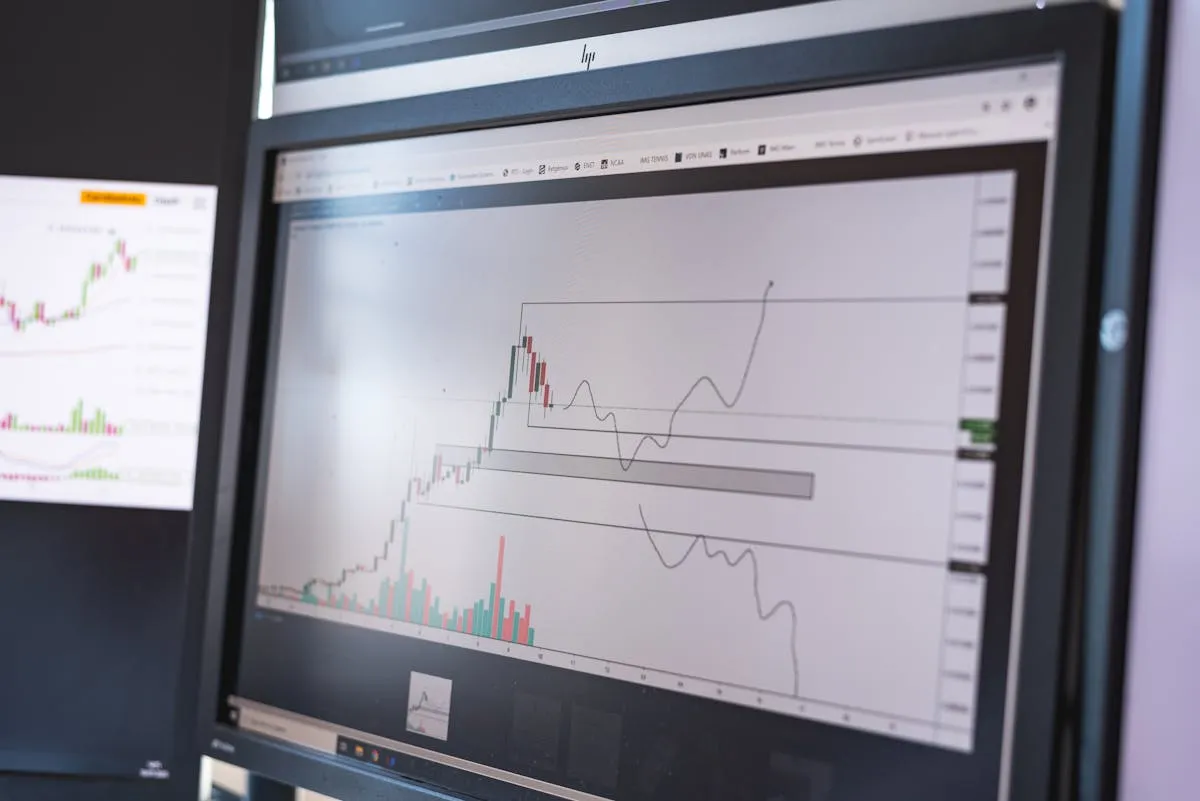 Trading charts on multiple monitors — the prediction market interface that drew millions of retail traders in 2024
