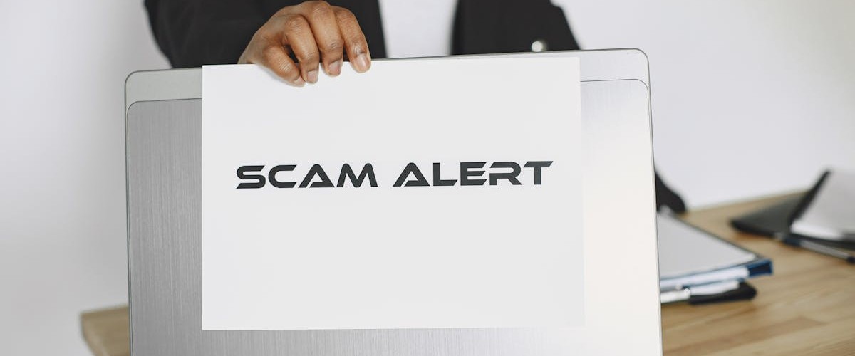 Scam alert warning on laptop screen